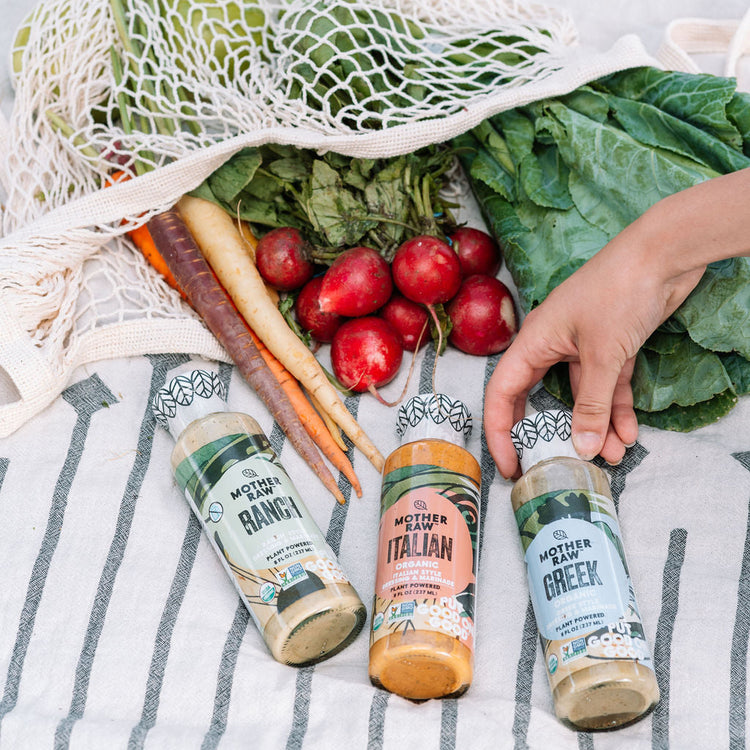 A bag of delicious groceries with Mother Raw dressing in front