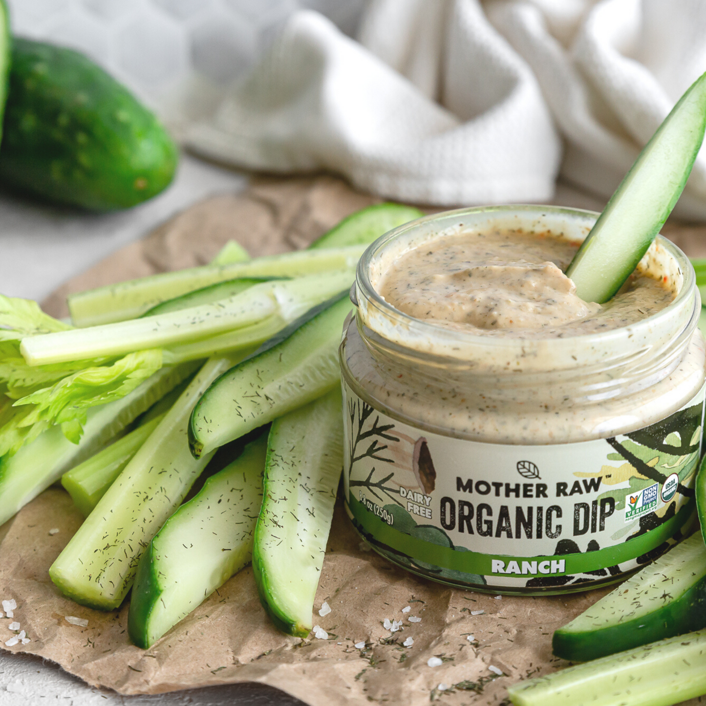 Organic Vegan Ranch Dip with Cucumber being dipped in it