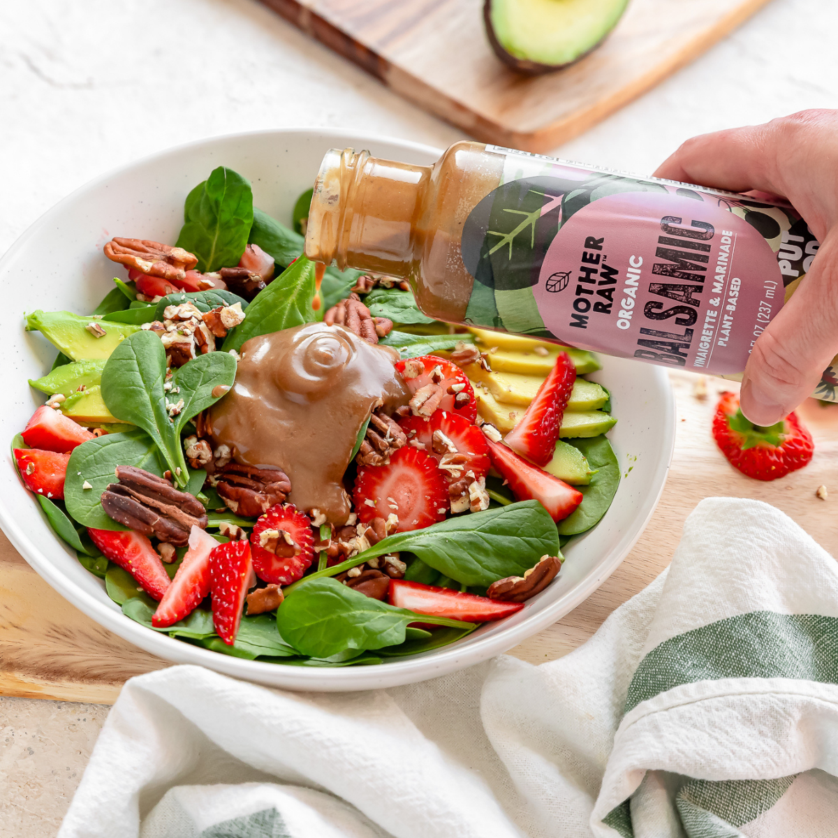 Balsamic Dressing Being Poured on Strawberry Salad